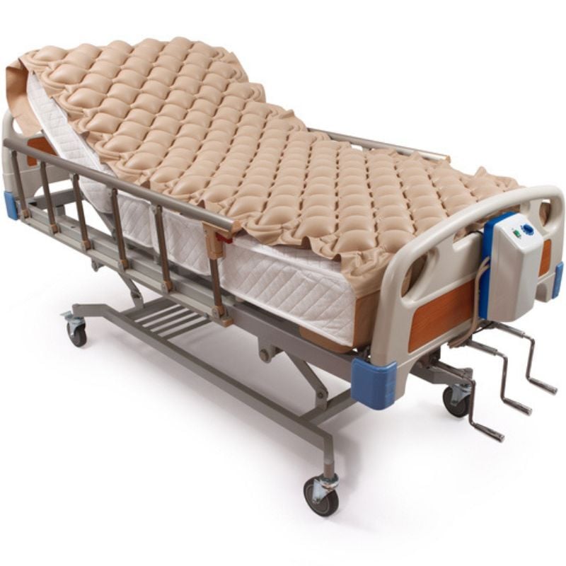 Tan pressure relief mattress on rolling frame.