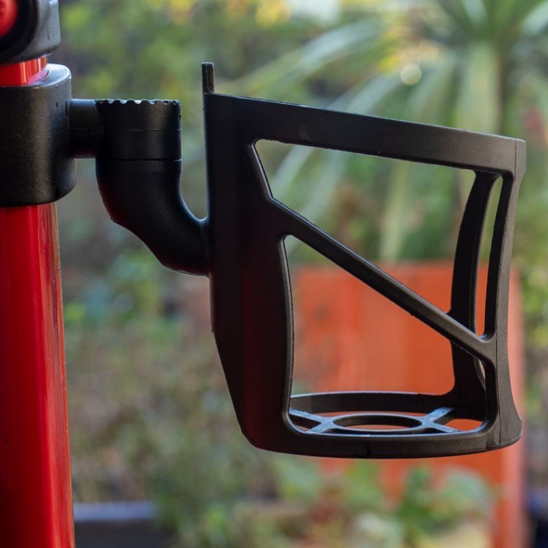 Cup holder attached to walking stroller.