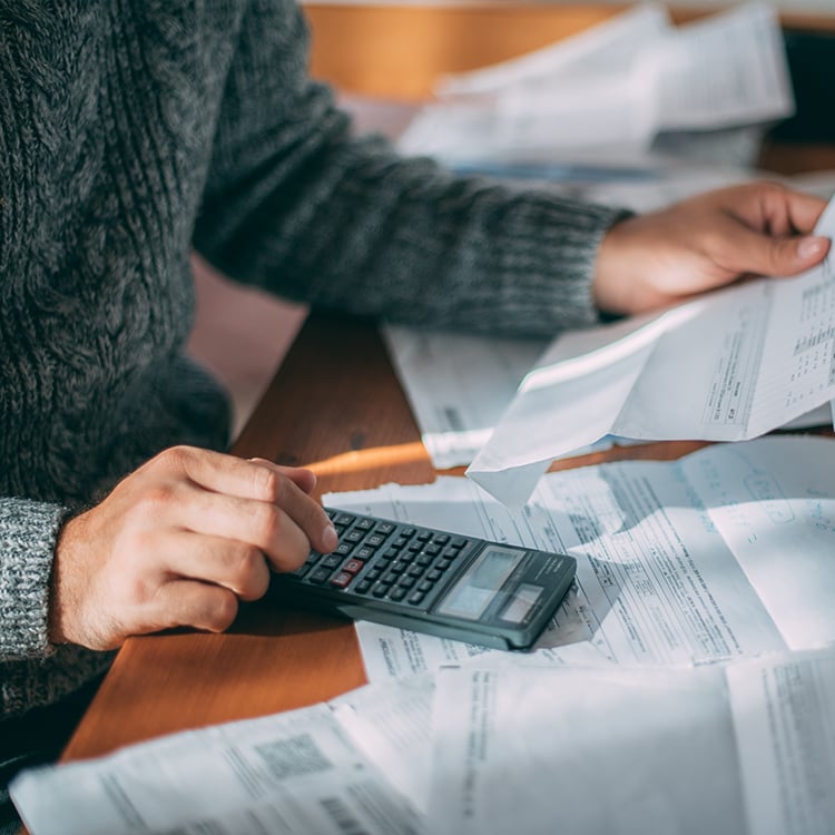 Woman sitting at desk reviewing APA's billing & insurance paperwork