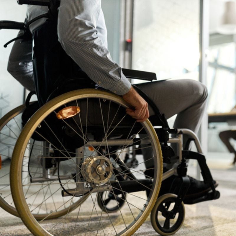 Person in wheelchair in hallway.
